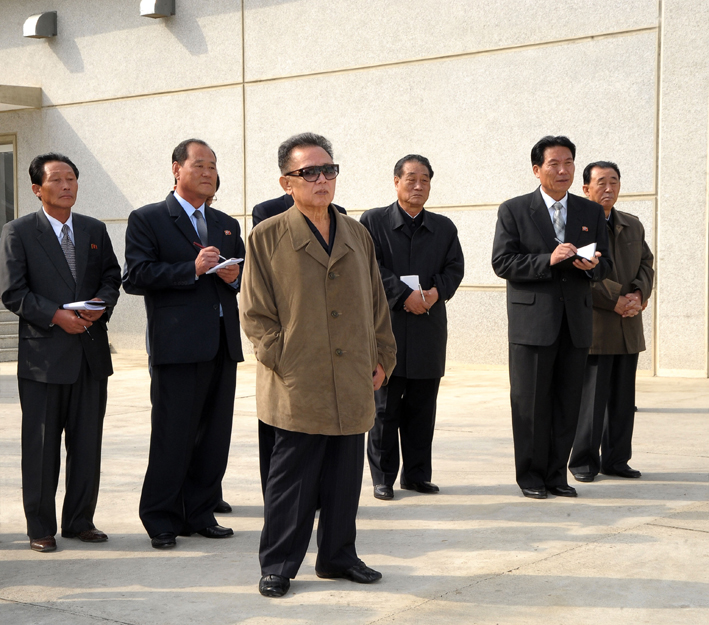 Kim Jong-il at the 26 September Pig Farm.  One may note Gen. Ri Myong-su at the far right without his KPA uniform. (Photo: KCNA)
