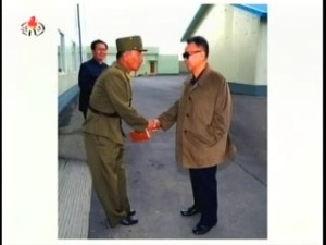 Kim Jong-il exchanges civilities with a manager of the Salmon Breeding Research Institute (Photo: Korean Central News Agency)