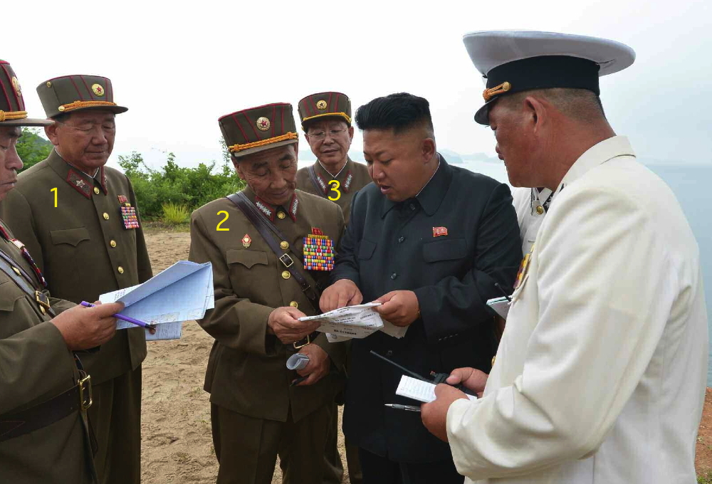Kim Jong Un confers with members of the KPA high command during an island landing drill.  Seen in attendance are VMar Hyong Pyong So (1), Director of the KPA General Political Department, Gen. Pyon In Son (2), Director of the KPA General Staff Operations Bureau, and Gen. Ri Yong Gil (3), Chief of the KPA General Staff (Photo: Rodong Sinmun).