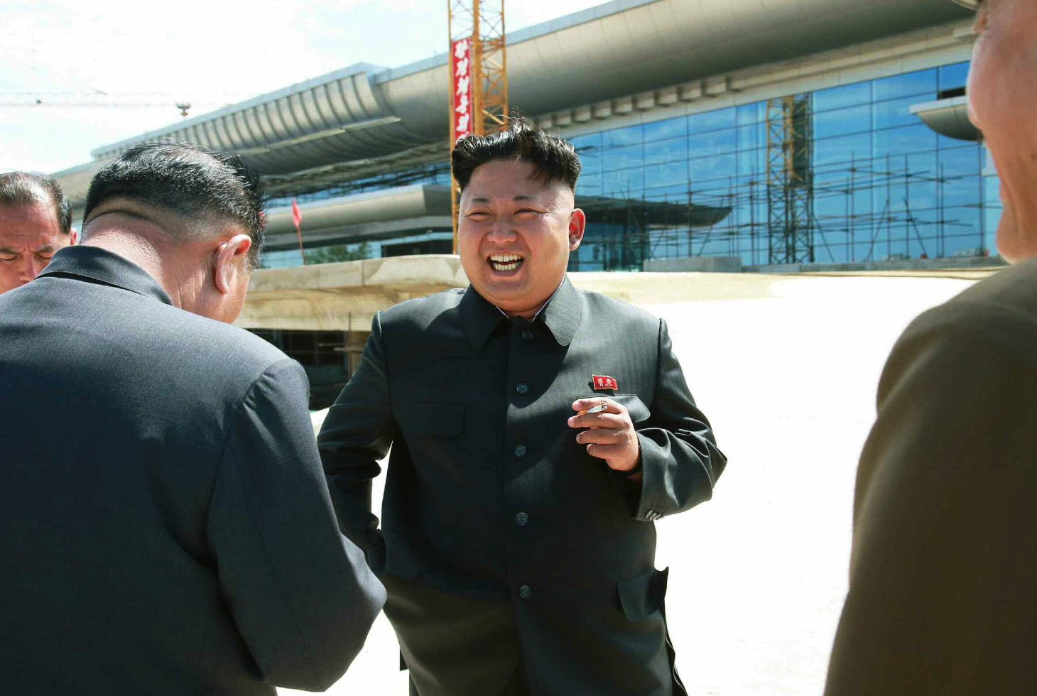 Kim Jong Un smokes a cigarette during his visit to the construction of a terminal at Pyongyang Airport (Photo: Rodong Sinmun).