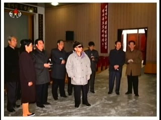 Kim Jong-il looking at production statistics at the Unhung Cooperative Farm.  Jang Song-thaek and Ri Je-gang are on the left, looking like two old people gossiping in church. (Photo: KCNA)