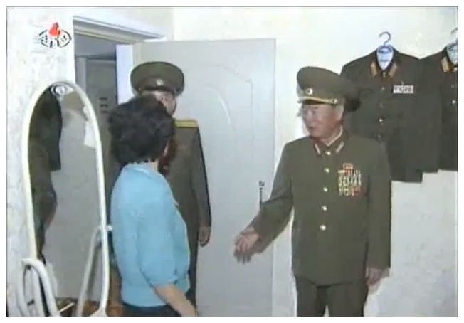 Gen. Ri Myong Su, Minister of People's Security and member of the National Defense Commission, meets a Changjon Street resident in her flat on 6 July 2012 (Photo: KCNA/KCTV still)
