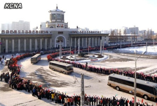 Buses carrying personnel who contributed to the 12 December 2012 U'nha-3 rocket launch ride past Pyongyang Central Railway Station prior to departing the city on 4 January 2013 (Photo: KCNA)