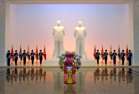 A floral basket from Kim Jong Un in front of statues of his grandfather Kim Il Sung and father Kim Jong Il at Ku'msusan in Pyongyang on 16 February 2013 (Photo: Rodong Sinmun)