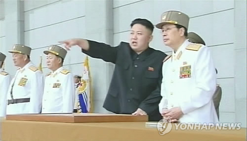 Kim Jong Un (2nd R) points to something at an event held at the plaza in front of Ku'msusan Memorial Palace in Pyongyang on 25 April 2013 to mark the KPA's official 81st anniversary.  KJU is seen talking to his uncle, Jang Song Taek (R), Vice Chairman of the DPRK National Defense Commission and Director of the KWP Administration Department.  (Photo: KCTV-Yonhap)