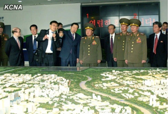 VMar Choe Ryong Hae (1), special envoy of Kim Jong Un, views a scale model of Beijing Economic and Technological Development Park.  Also in attendance is Col. Gen. Gen. Ri Yong Gil (2), chief of the KPA General Staff Operations Bureau (Photo: KCNA).