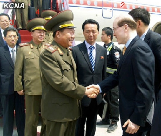 VMar Choe Ryong Hae (1) shakes hands with Liu Jieyi (2), deputy director of the Communist Party of China Central Committee International Liaison Department, after arriving in Beijing on 22 May 2013.  Also seen in attendance are Kim Song Nam (3) and Col. Gen. Ri Yong Gil (4) (Photo: KCNA).