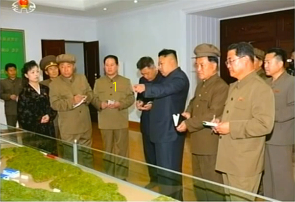 Kim Jong Un visits the January 18 General Machinery Plant in South P'yo'ngan Province in May 2014.  Also in attendance is Hong Yong Chil (1) a leading party official in the development and production of missiles and WMDs (Photo: KCTV).