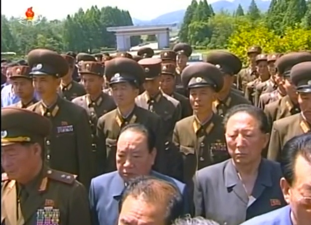 Senior officials of the DPRK's military industrial complex attend a burial ceremony for Jon Pyong Ho at Patriotic Martyrs' Cemetery in Ryongso'ng District, Pyongyang, on 10 July 2014.  Among those in attendance is Hong Sung Mu (right) (Photo: KCTV).