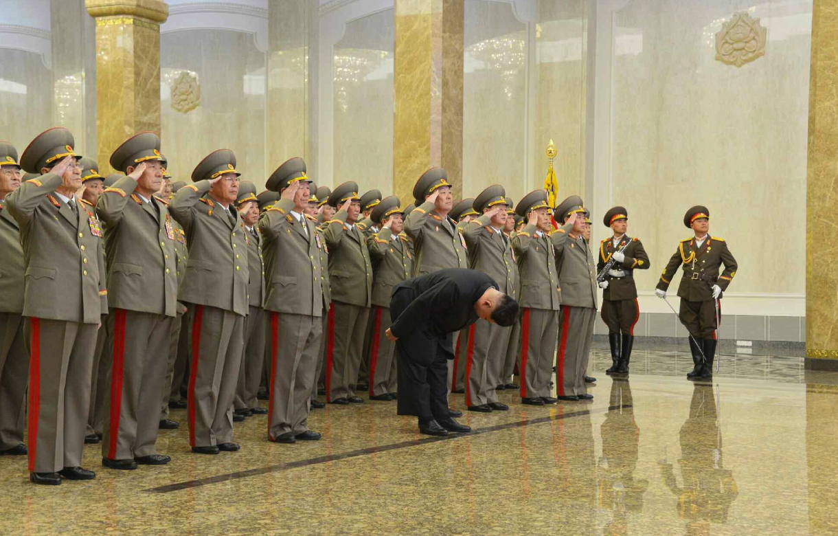 Kim Jong Un bows whilst senior Korean People's Army officials salute in front of statues of Kim Il Sung and Kim Jong Il at Ku'msusan Palace of the Sun in Pyongyang at midnight on February 16, 2015 (Photo: Rodong Sinmun).