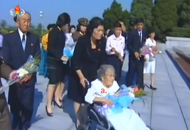 Workers' Party of Korea Central Committee Member Hwang Sun Hui delivers a floral bouquet to the memorial bust of her husband Ryu Kyong Su at the Revolutionary Martyrs' Cemetery in Pyongyang on September 10, 2015 (Photo: KCTV screen grab).