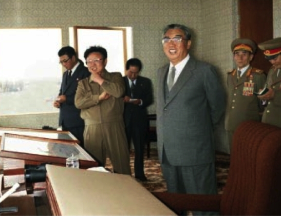 Late DPRK president and founder Kim Il Sung and late DPRK leader Kim Jong Il watch military exercises in 1989. Also in attendance were Yon Hyong Muk and O Jin U (Photo: Rodong Sinmun).