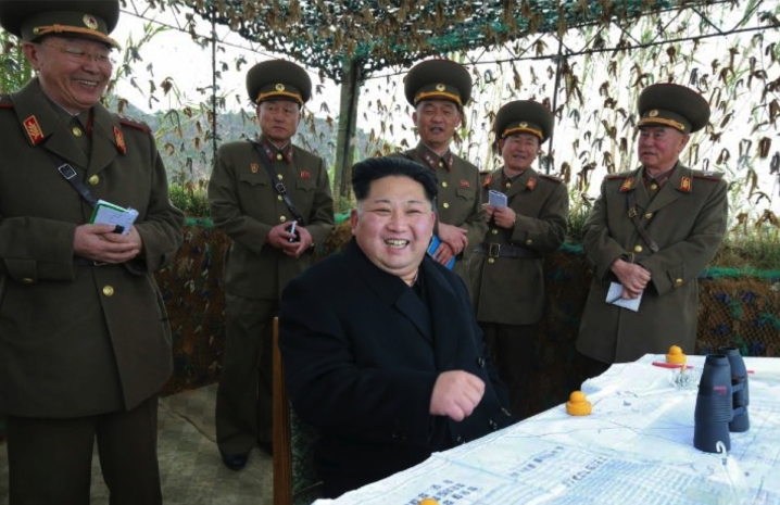 Kim Jong Un smiles during an artillery exercise during his inspection of Mahap Islet in a photo which appeared top center on the cover of the November 11, 2016 edition of the WPK daily organ Rodong Sinmun (Photo: Rodong Sinmun).