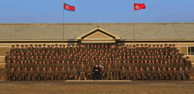 Commemorative photograph of Kim Jong Un and members of the sub-unit subordinate to KPA Unit #1344 which appeared on the front page of the November 9, 2016 edition of the WPK daily organ Rodong Sinmun (Photo: Rodong Sinmun).