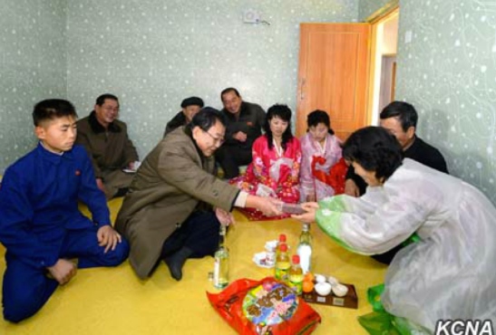 WPK Vice Chairman for Munitions Industry Ri Man Gon presents a gift whilst attending a house warming in North Hamgyo'ng Province (Photo: KCNA).